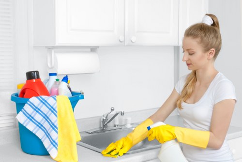 Professional cleaner using equipment safely during routine work